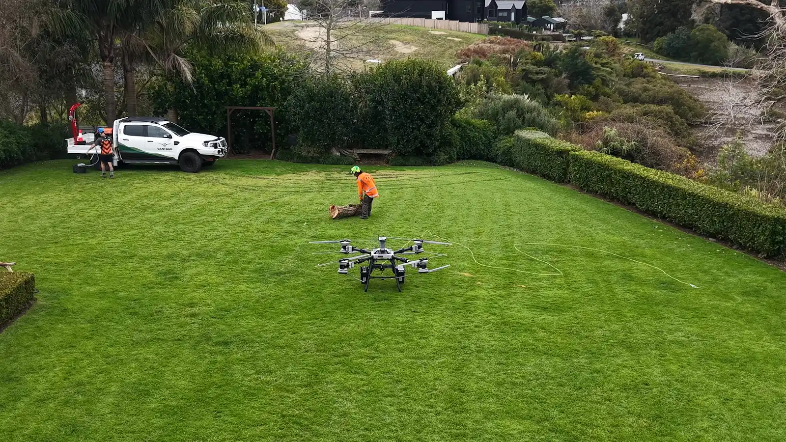 DJI Agras T100 at the landing zone with an oak section and Vantage vehicle at Riverhead Tavern