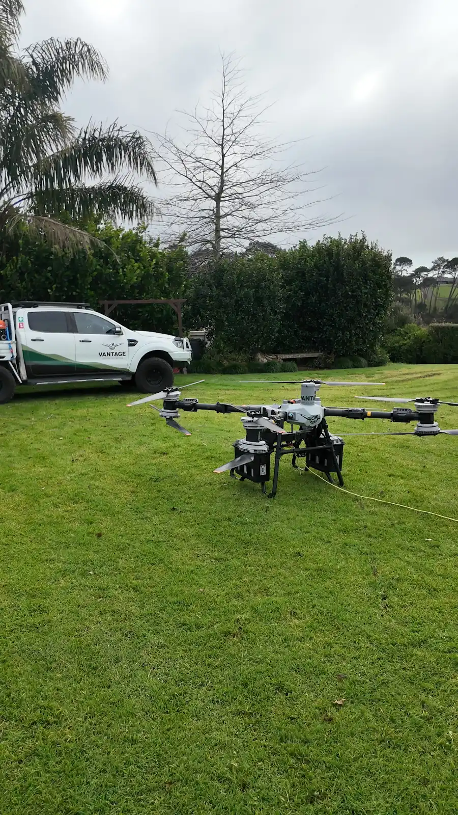 DJI Agras T100 heavy-lift drone and Vantage Drone Services vehicle at Riverhead Tavern